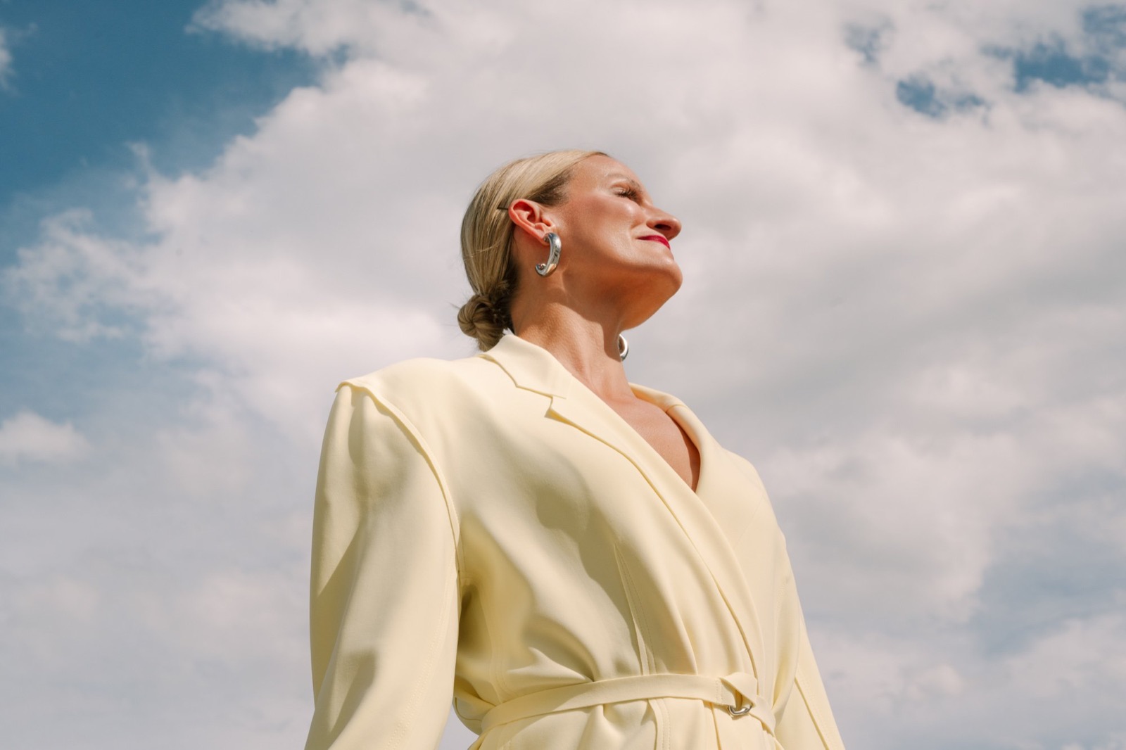 Dr. Marie Claire Bourque outdoors in a pale yellow suit